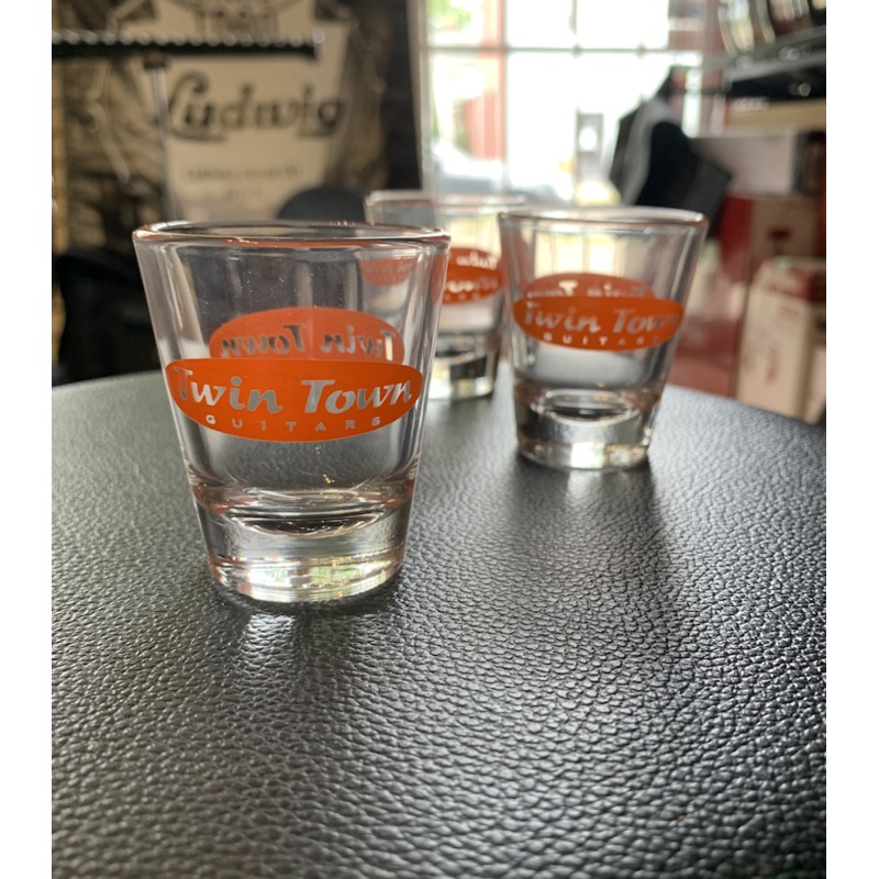 twin-town-guitars-shot-glass-clear-with-orange-logo Twin Town Guitars Shot Glass Clear with Orange Logo
